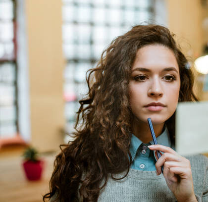 Concentrated woman making plan on sticky notes.