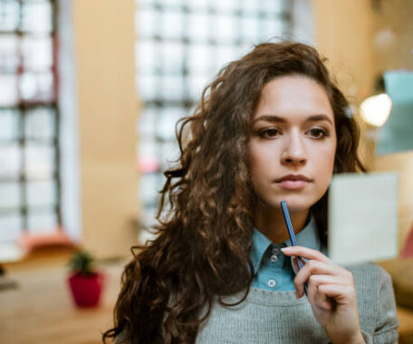 Concentrated woman making plan on sticky notes.