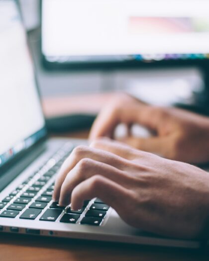 Upclose of hands typing on laptop