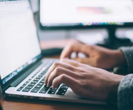 Upclose of hands typing on laptop