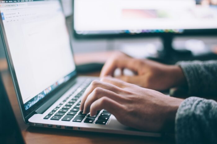 Upclose of hands typing on laptop