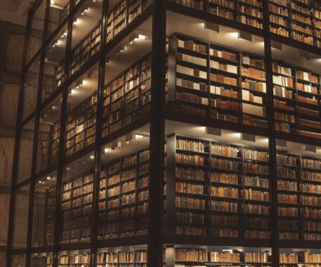 Multiple stories of bookshelves in dim lighting